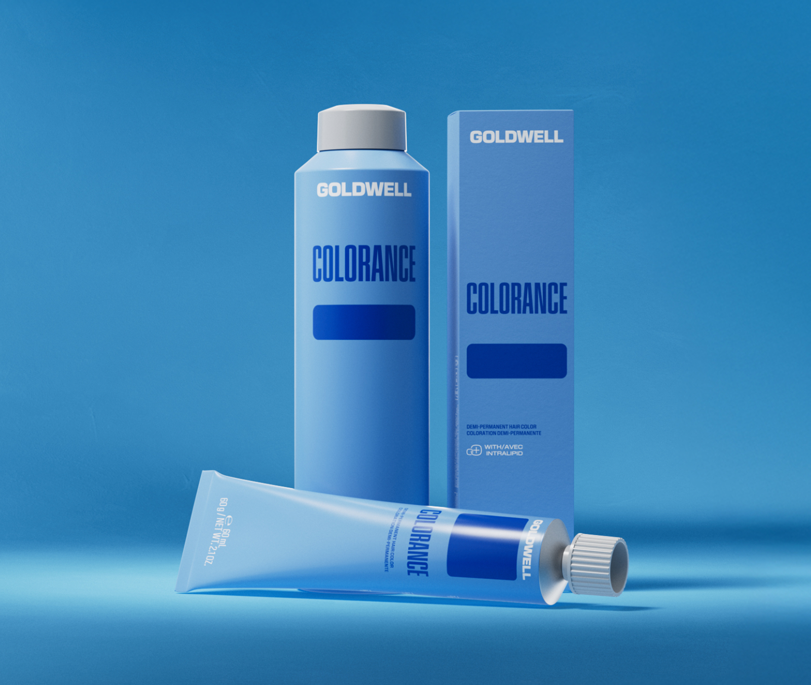 Goldwell Colorance demi-permanent hair color bottle, box, and tube on a blue background, product photo