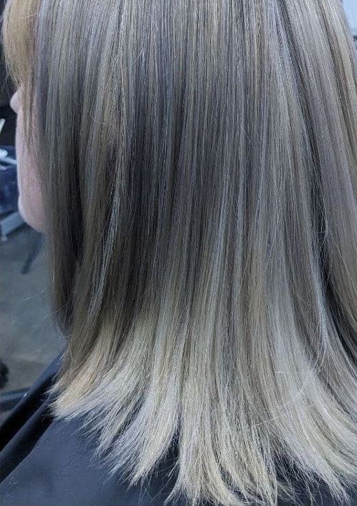 Smooth, even silver blonde hair after a color correction on a real client
