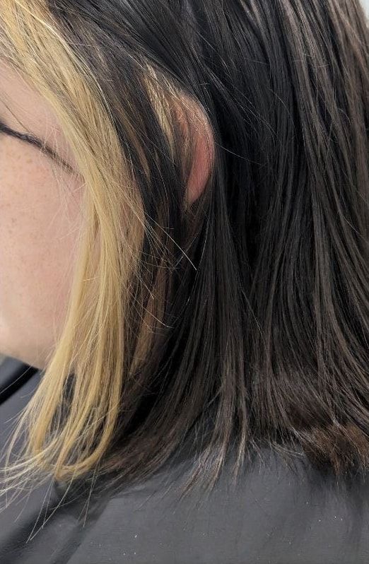 Before: dark brown shoulder-length hair with a chunky golden blonde panel at the front, seen from the side