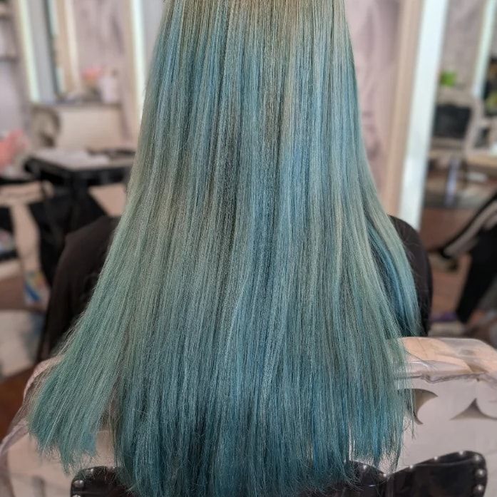 Before: long straight hair from behind in a faded, uneven teal