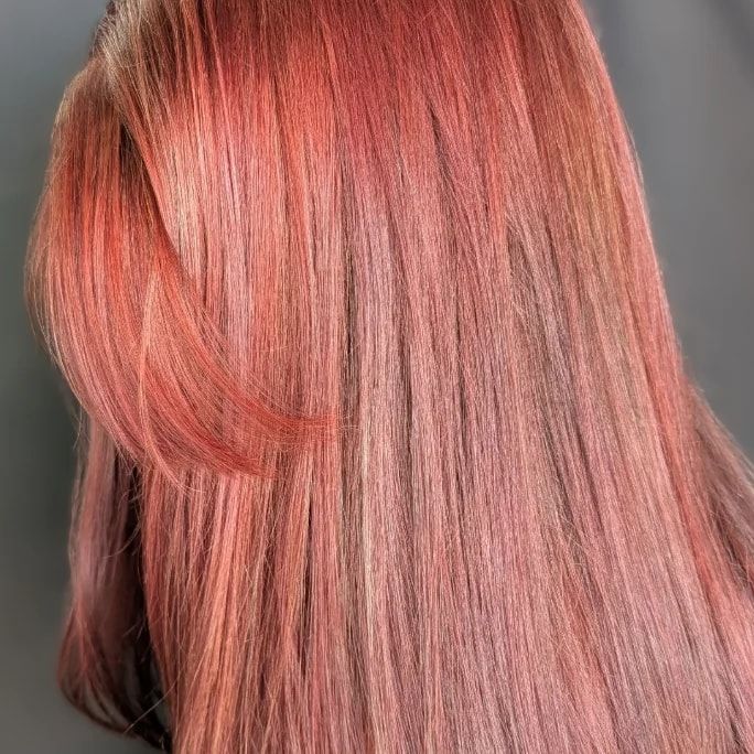 Sleek, glossy rose copper hair on a real client